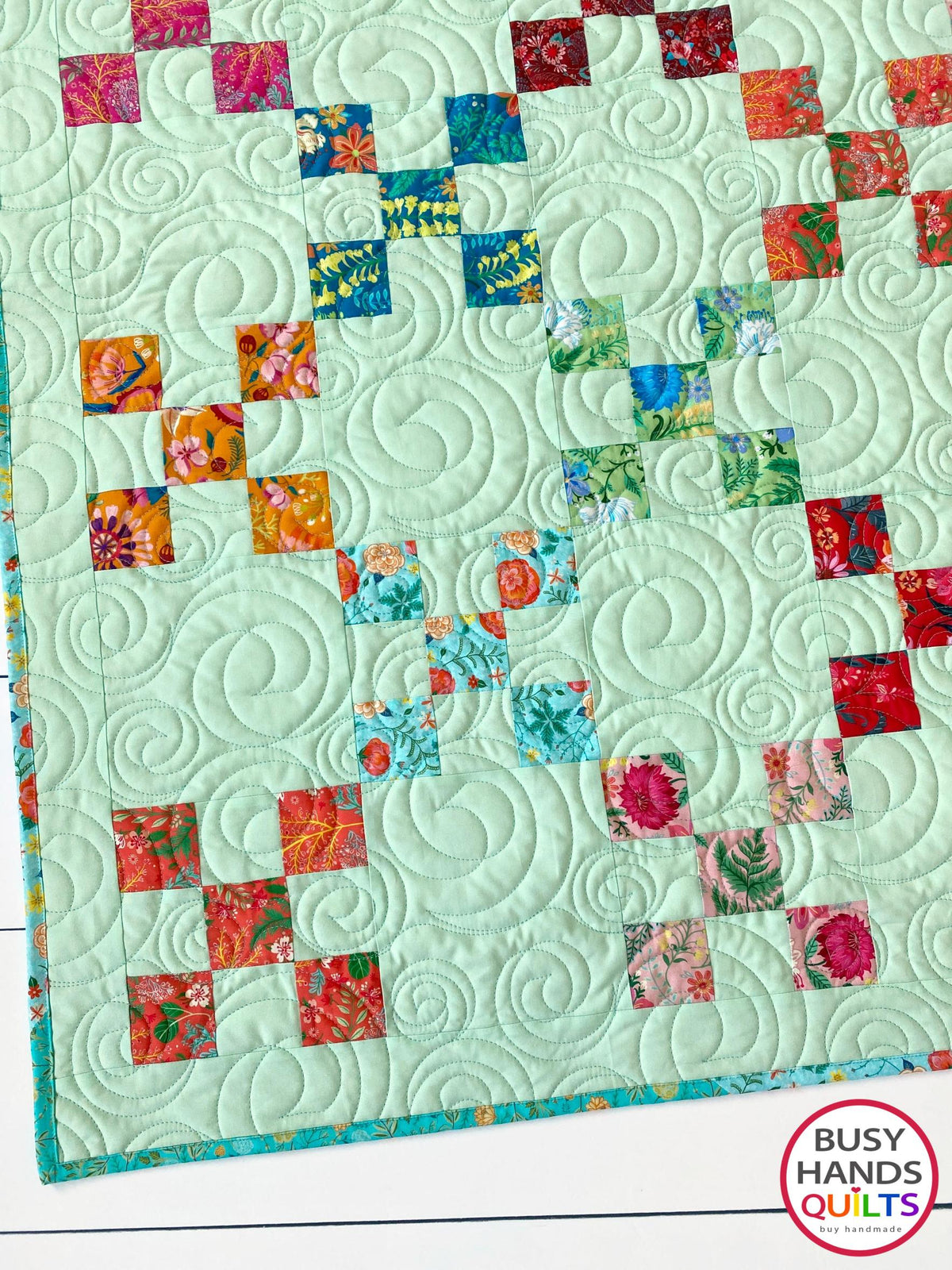 Handmade, heirloom-quality traditional 9-patch quilt in pretty floral prints on a solid mint colored background. Perfect as a Christmas present idea or birthday gift idea for women and young girls.