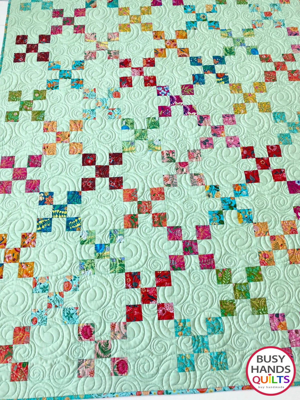 Handmade, heirloom-quality traditional 9-patch quilt in pretty floral prints on a solid mint colored background. Perfect as a Christmas present idea or birthday gift idea for women and young girls.
