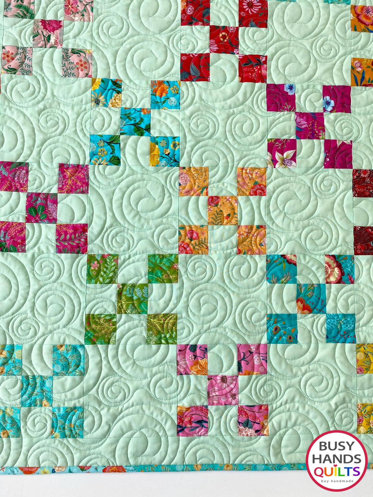 Handmade, heirloom-quality traditional 9-patch quilt in pretty floral prints on a solid mint colored background. Perfect as a Christmas present idea or birthday gift idea for women and young girls.