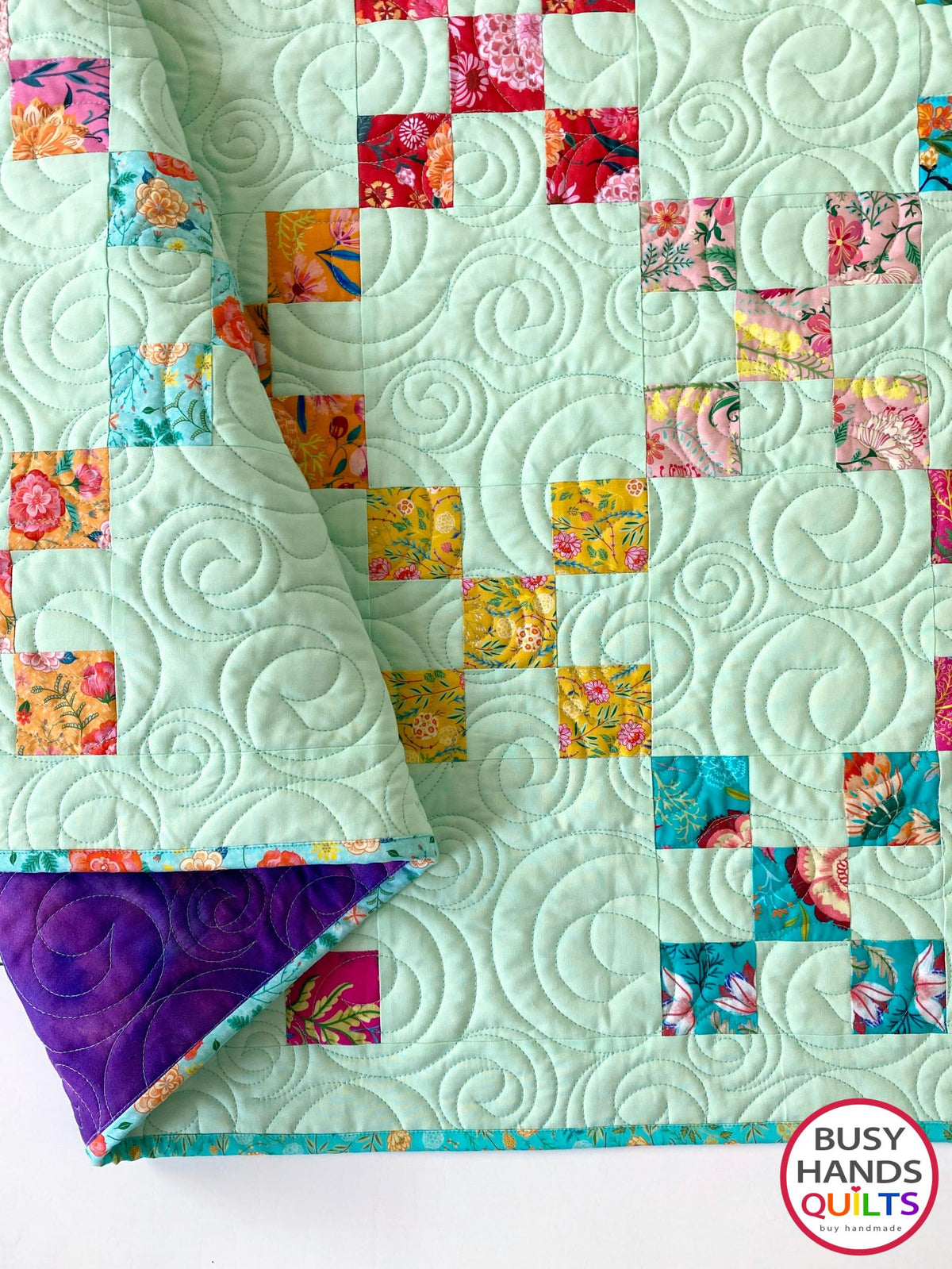 Handmade, heirloom-quality traditional 9-patch quilt in pretty floral prints on a solid mint colored background. Perfect as a Christmas present idea or birthday gift idea for women and young girls.