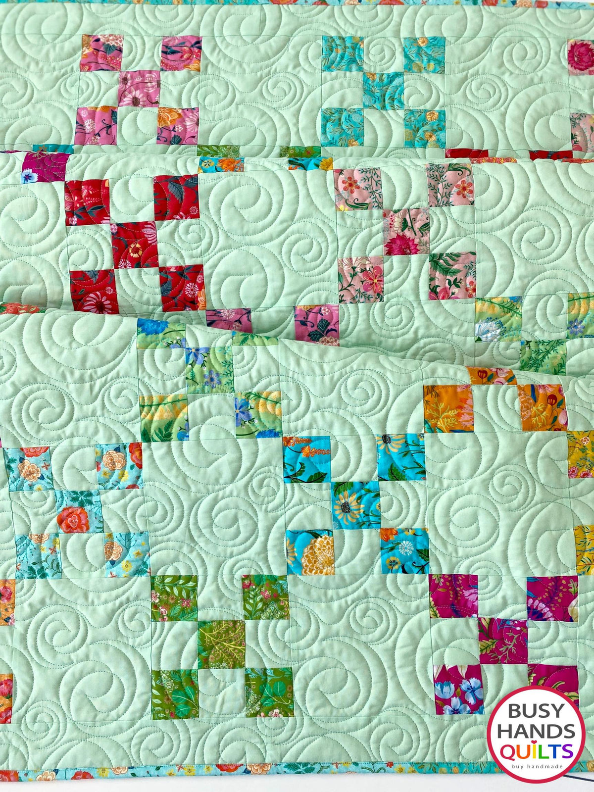Handmade, heirloom-quality traditional 9-patch quilt in pretty floral prints on a solid mint colored background. Perfect as a Christmas present idea or birthday gift idea for women and young girls.