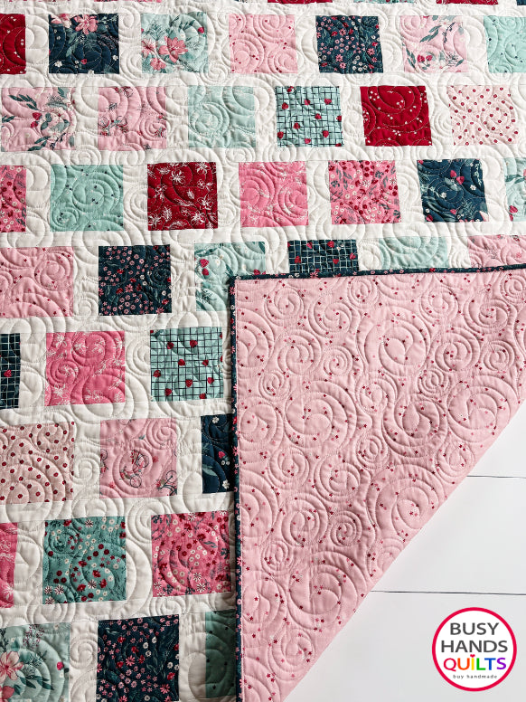 Handmade, heirloom-quality patchwork throw quilt in red, pink, teal, and creamy white. Perfect Christmas present for women and young ladies, or a birthday gift idea.