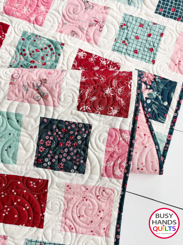 Handmade, heirloom-quality patchwork throw quilt in red, pink, teal, and creamy white. Perfect Christmas present for women and young ladies, or a birthday gift idea.