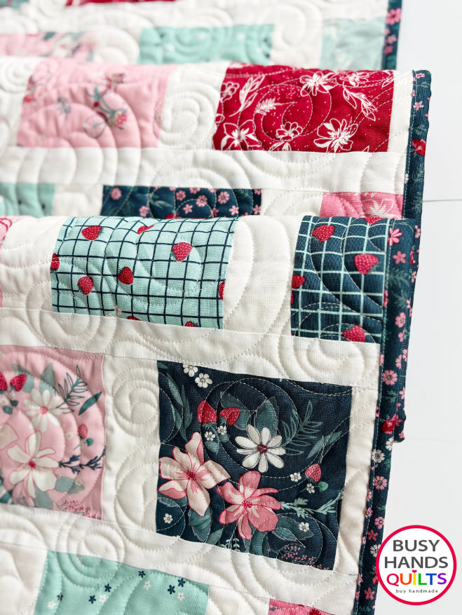 Handmade, heirloom-quality patchwork throw quilt in red, pink, teal, and creamy white. Perfect Christmas present for women and young ladies, or a birthday gift idea.