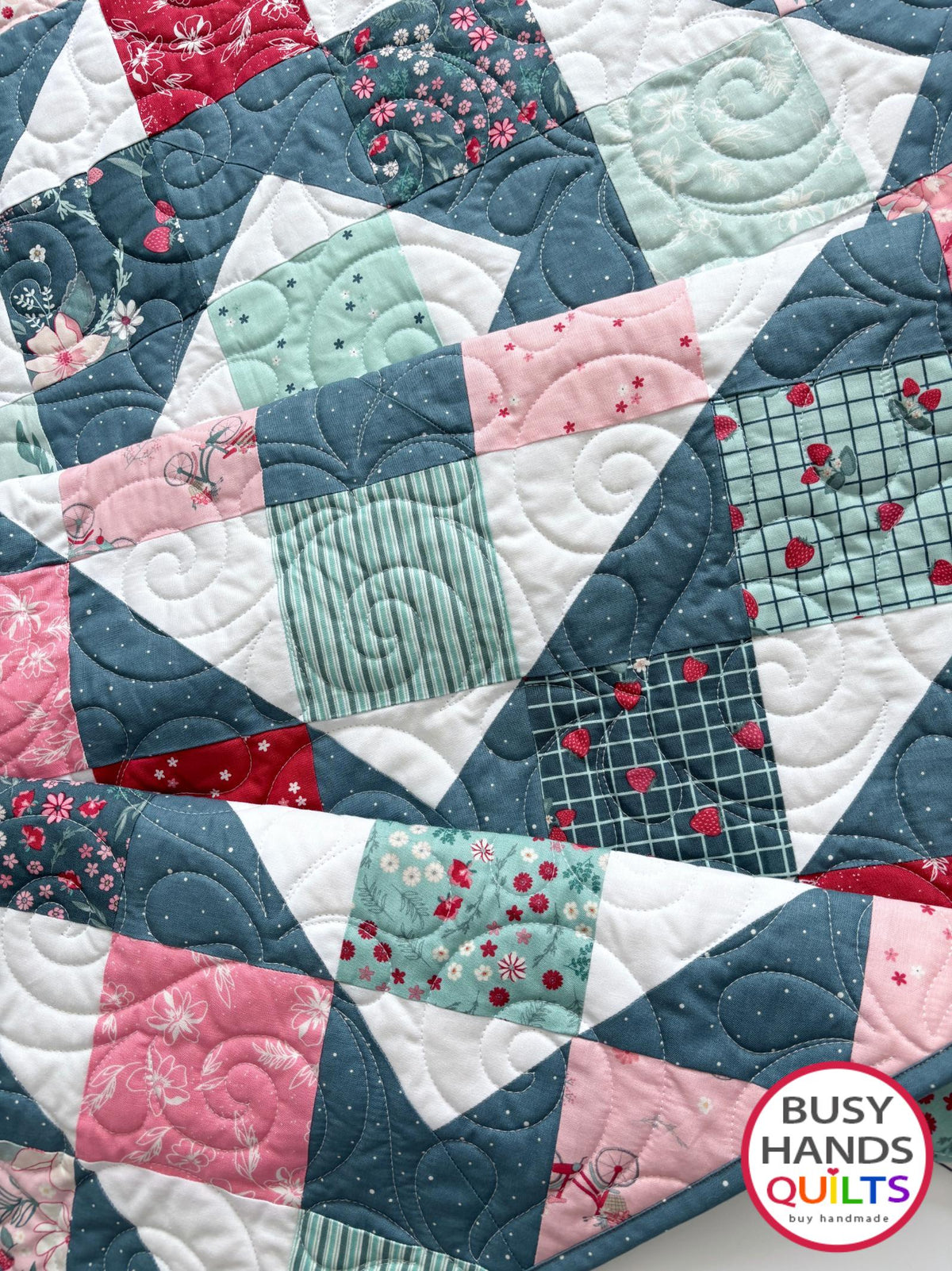 Handmade, heirloom-quality throw quilt in Skip to My Lou quilt design in pink, red, and teal florals. Perfect Christmas present idea, or birthday gift idea for women or young girl.