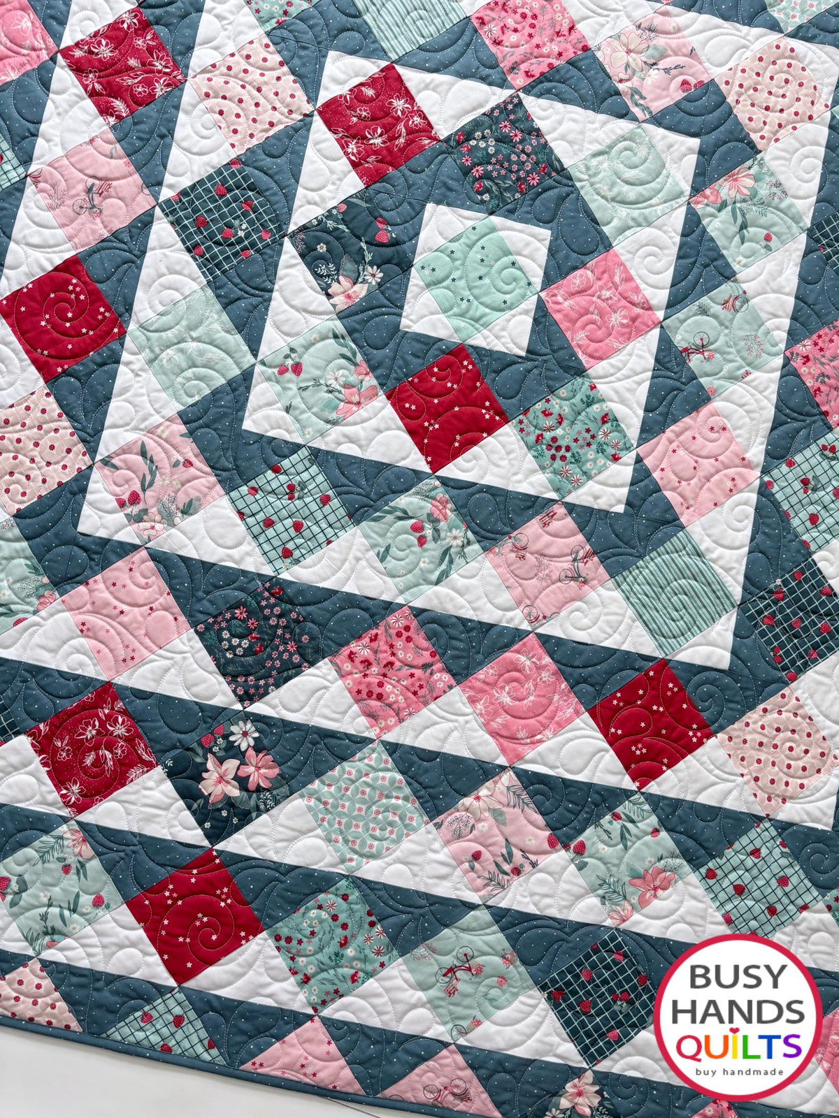 Handmade, heirloom-quality throw quilt in Skip to My Lou quilt design in pink, red, and teal florals. Perfect Christmas present idea, or birthday gift idea for women or young girl.