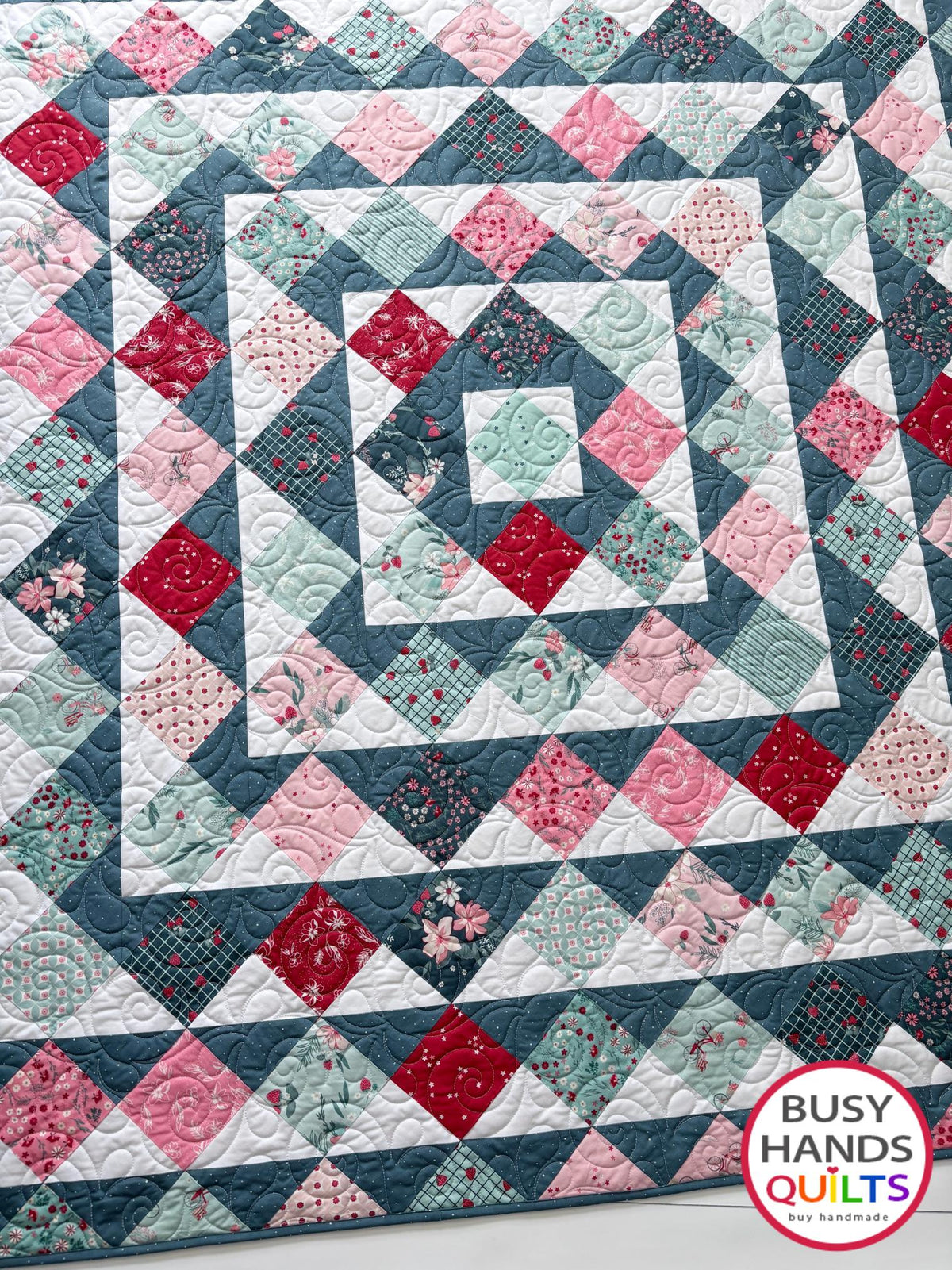 Handmade, heirloom-quality throw quilt in Skip to My Lou quilt design in pink, red, and teal florals. Perfect Christmas present idea, or birthday gift idea for women or young girl.