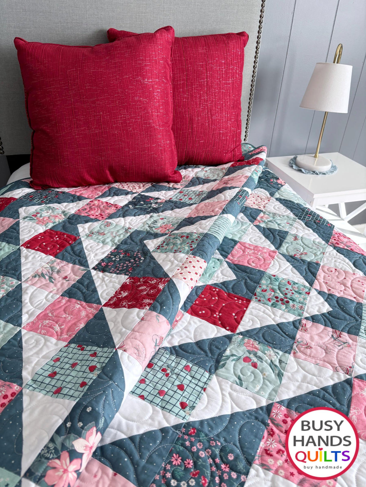 Handmade, heirloom-quality throw quilt in Skip to My Lou quilt design in pink, red, and teal florals. Perfect Christmas present idea, or birthday gift idea for women or young girl.