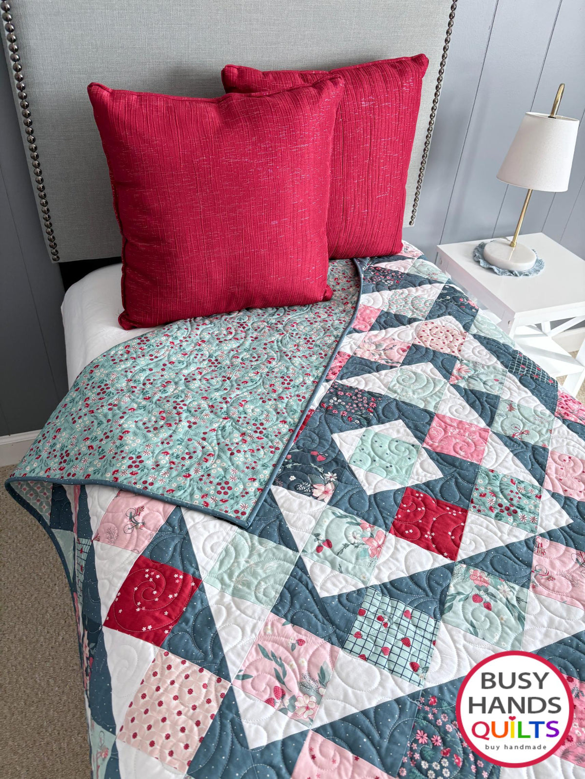 Handmade, heirloom-quality throw quilt in Skip to My Lou quilt design in pink, red, and teal florals. Perfect Christmas present idea, or birthday gift idea for women or young girl.