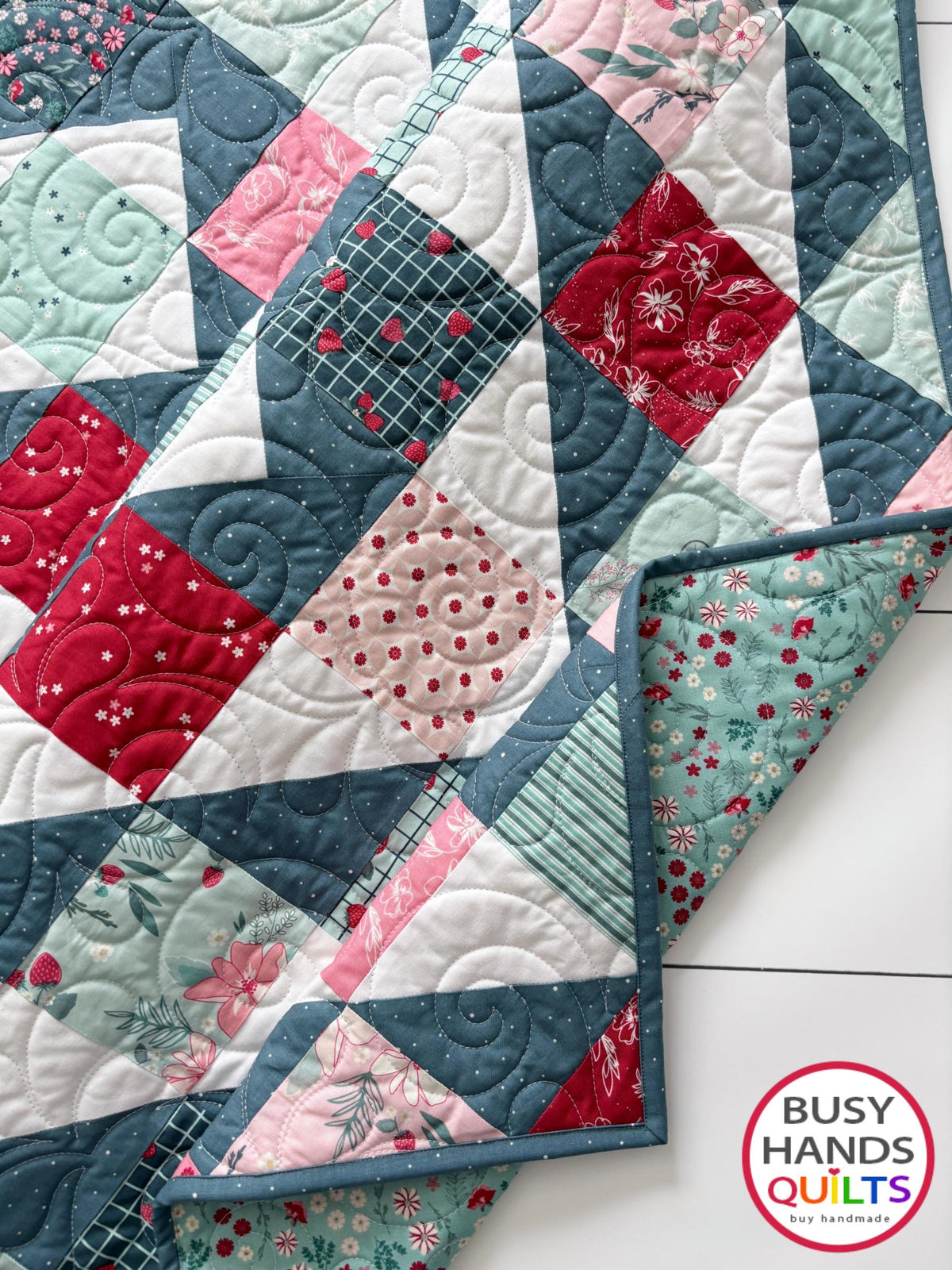 Handmade, heirloom-quality throw quilt in Skip to My Lou quilt design in pink, red, and teal florals. Perfect Christmas present idea, or birthday gift idea for women or young girl.