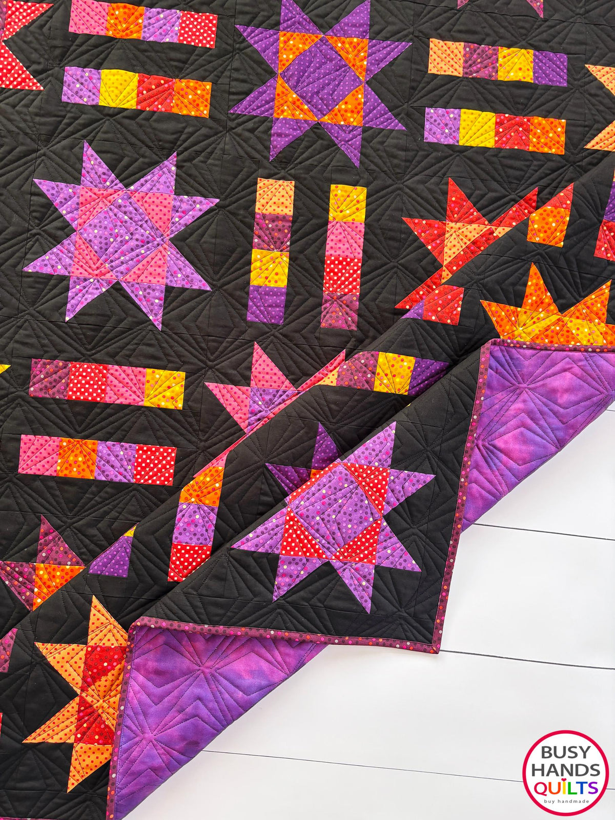 Handmade, heirloom-quality throw star and stripe quilt in vivid purple, pink, red, orange, and yellow. Perfect Christmas present idea, birthday gift ideas for teens, and wedding gifts for brides.
