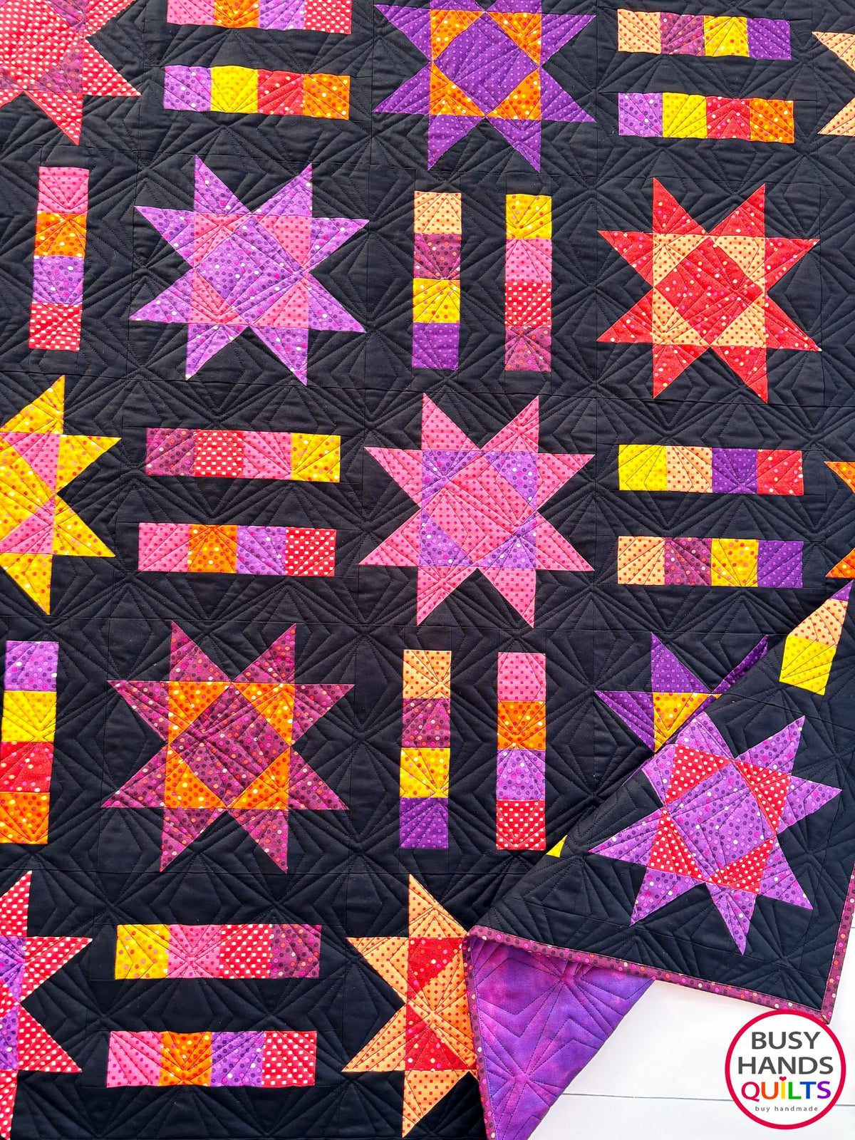 Handmade, heirloom-quality throw star and stripe quilt in vivid purple, pink, red, orange, and yellow. Perfect Christmas present idea, birthday gift ideas for teens, and wedding gifts for brides.
