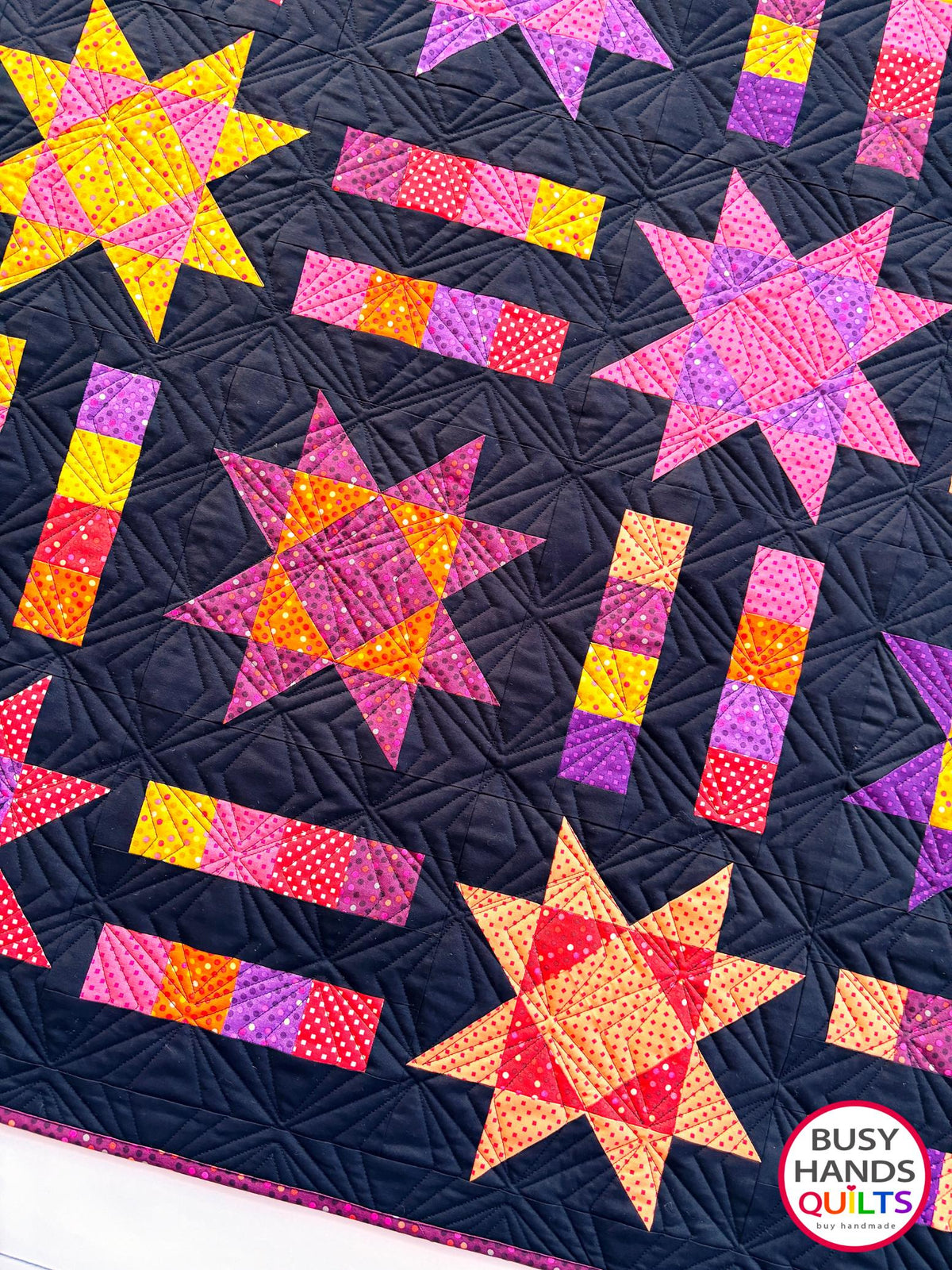 Handmade, heirloom-quality throw star and stripe quilt in vivid purple, pink, red, orange, and yellow. Perfect Christmas present idea, birthday gift ideas for teens, and wedding gifts for brides.