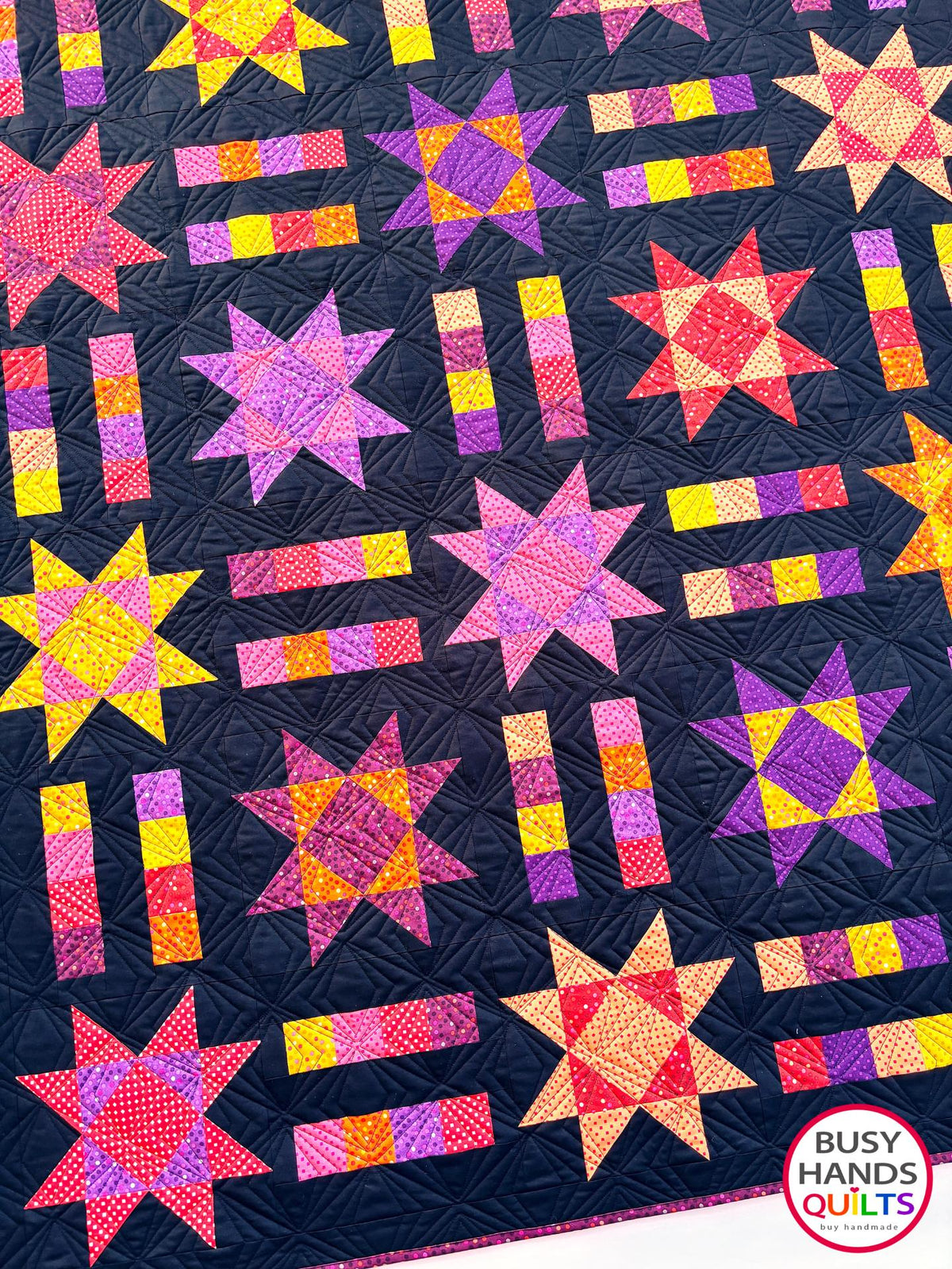 Handmade, heirloom-quality throw star and stripe quilt in vivid purple, pink, red, orange, and yellow. Perfect Christmas present idea, birthday gift ideas for teens, and wedding gifts for brides.