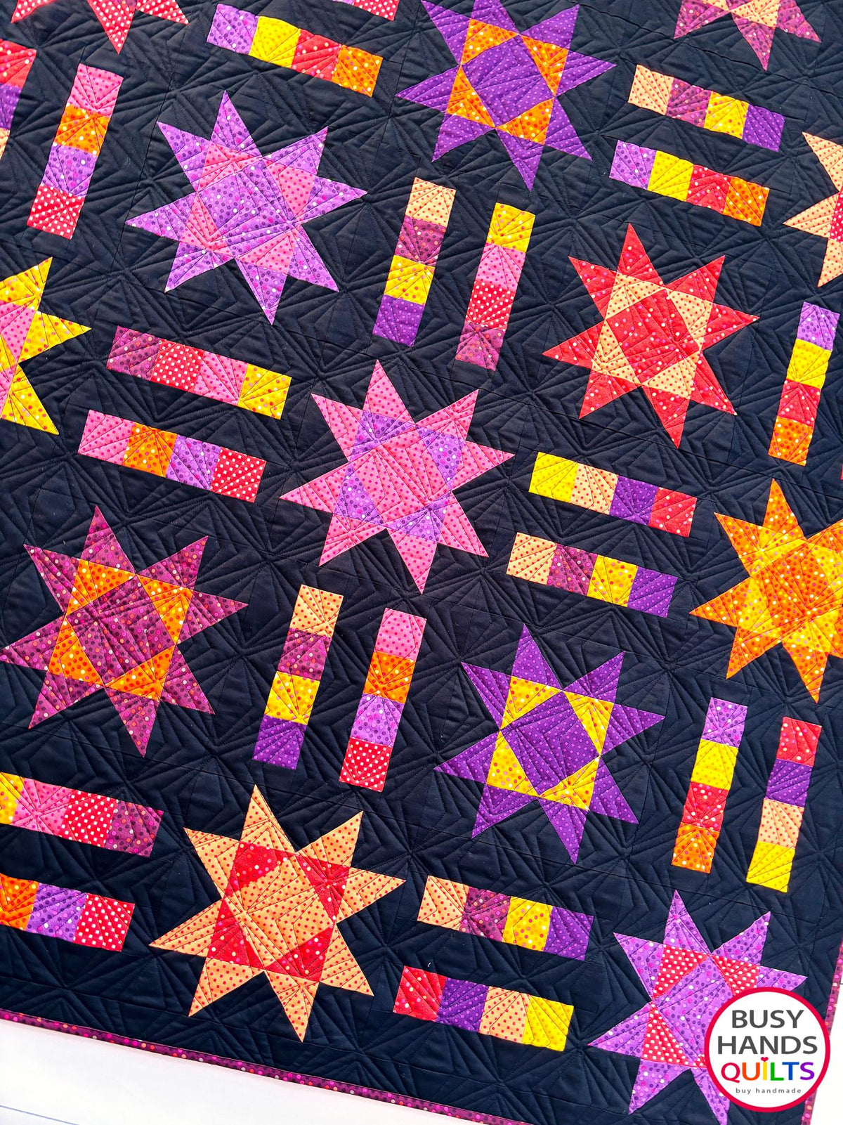 Handmade, heirloom-quality throw star and stripe quilt in vivid purple, pink, red, orange, and yellow. Perfect Christmas present idea, birthday gift ideas for teens, and wedding gifts for brides.