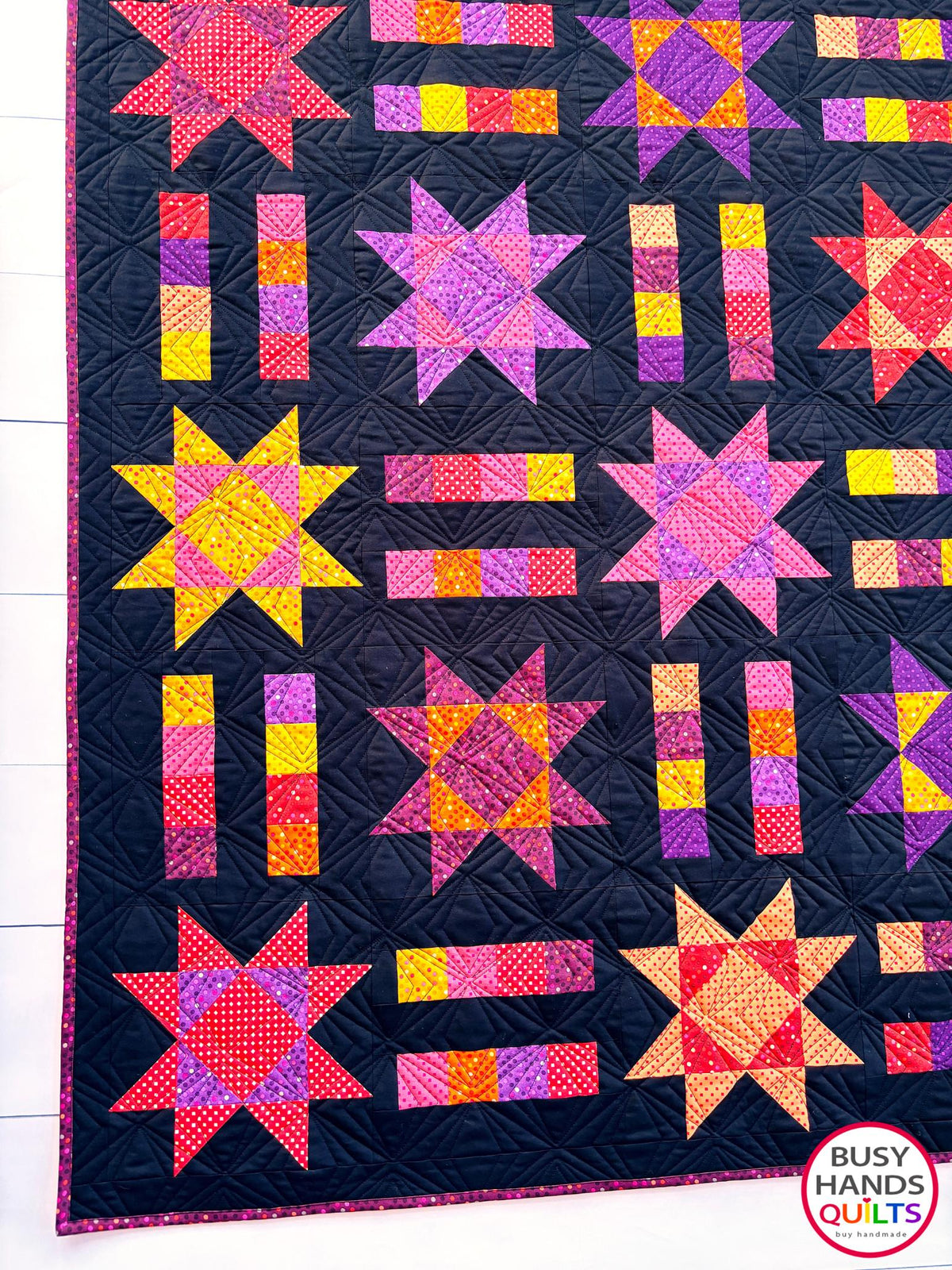 Handmade, heirloom-quality throw star and stripe quilt in vivid purple, pink, red, orange, and yellow. Perfect Christmas present idea, birthday gift ideas for teens, and wedding gifts for brides.