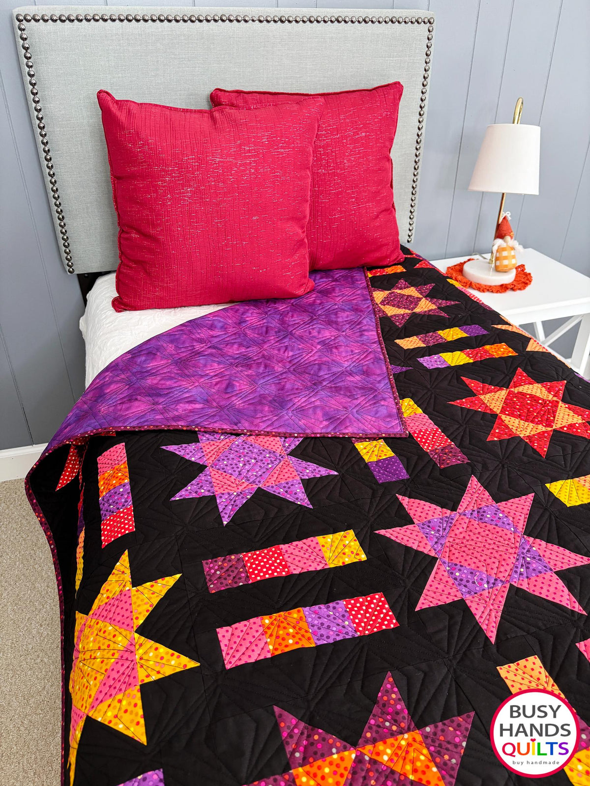 Handmade, heirloom-quality throw star and stripe quilt in vivid purple, pink, red, orange, and yellow. Perfect Christmas present idea, birthday gift ideas for teens, and wedding gifts for brides.
