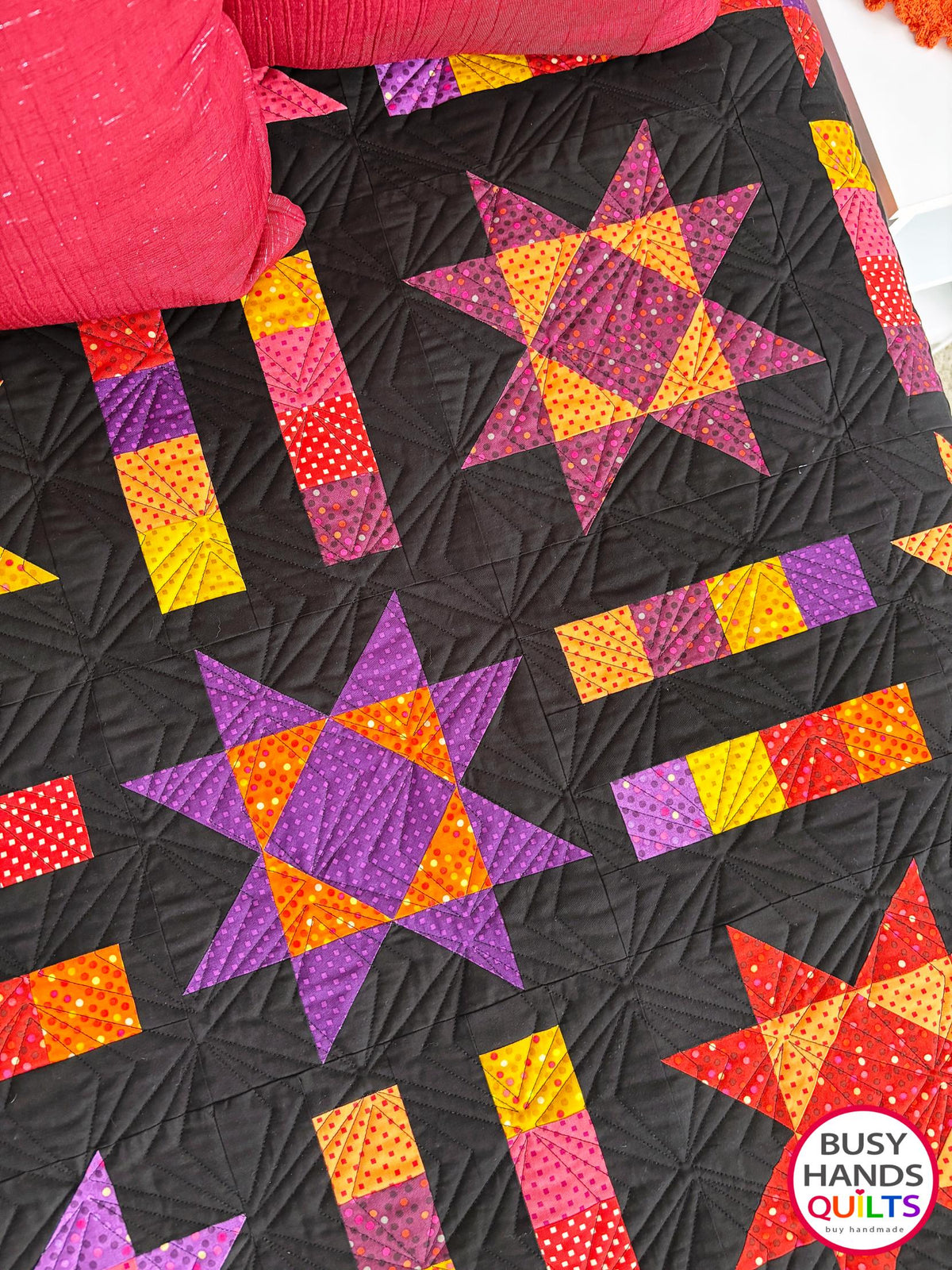 Handmade, heirloom-quality throw star and stripe quilt in vivid purple, pink, red, orange, and yellow. Perfect Christmas present idea, birthday gift ideas for teens, and wedding gifts for brides.