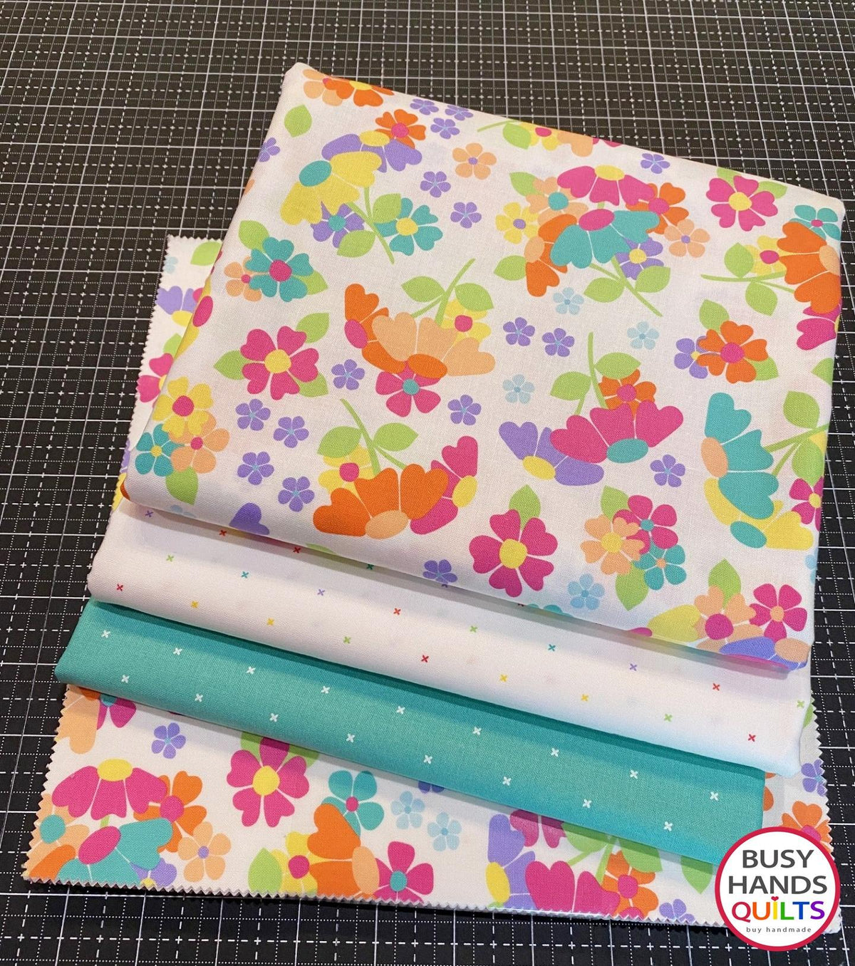 Nautical News twin size patchwork bed quilt in purple, yellow, mint green, orange, pink on a bed in a young girl's bedroom in Joysome fabrics, pattern by Busy Hands Quilts